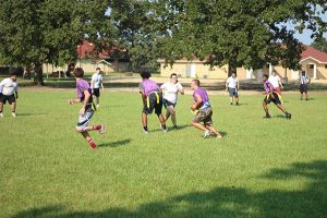 college students playing flag football