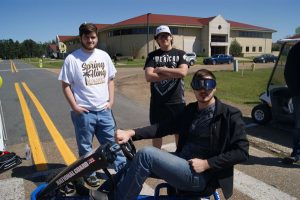 three white males driving go-carts