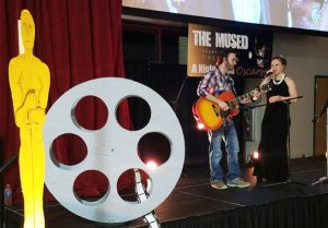 guy playing guitar and girl singing
