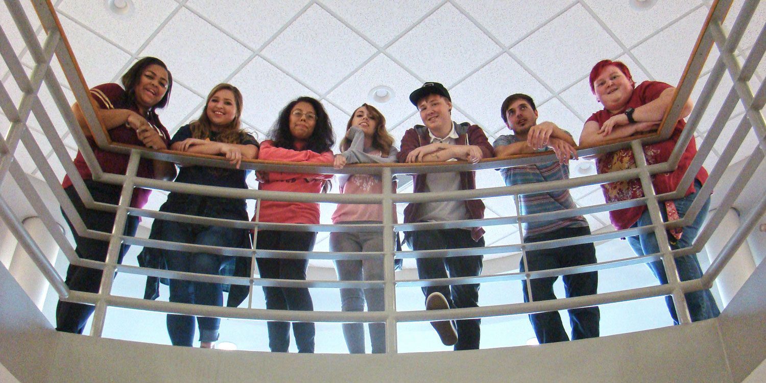 students standing at a rail