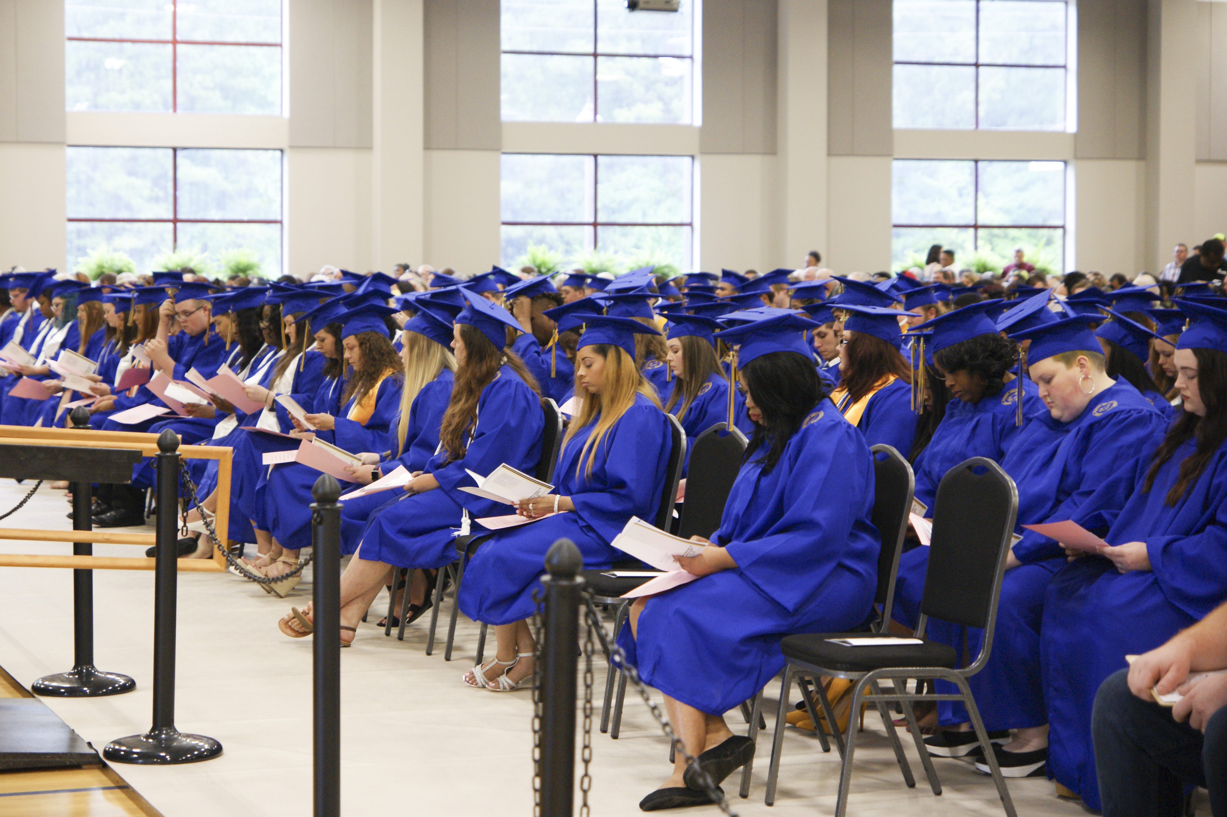college graduates in hat and gowns