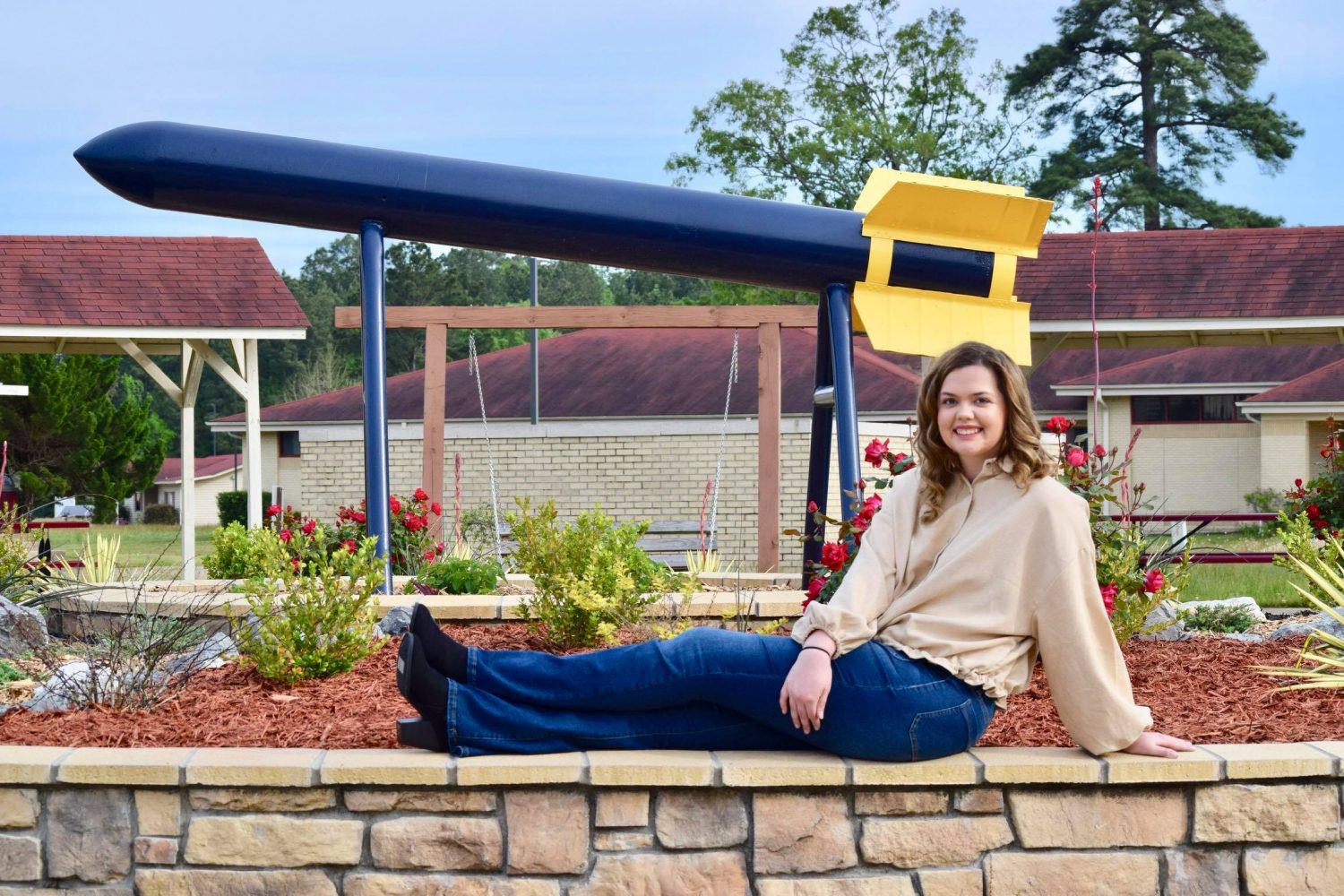 college student and flower bed