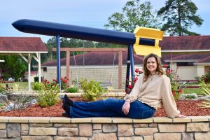 college student and flower bed