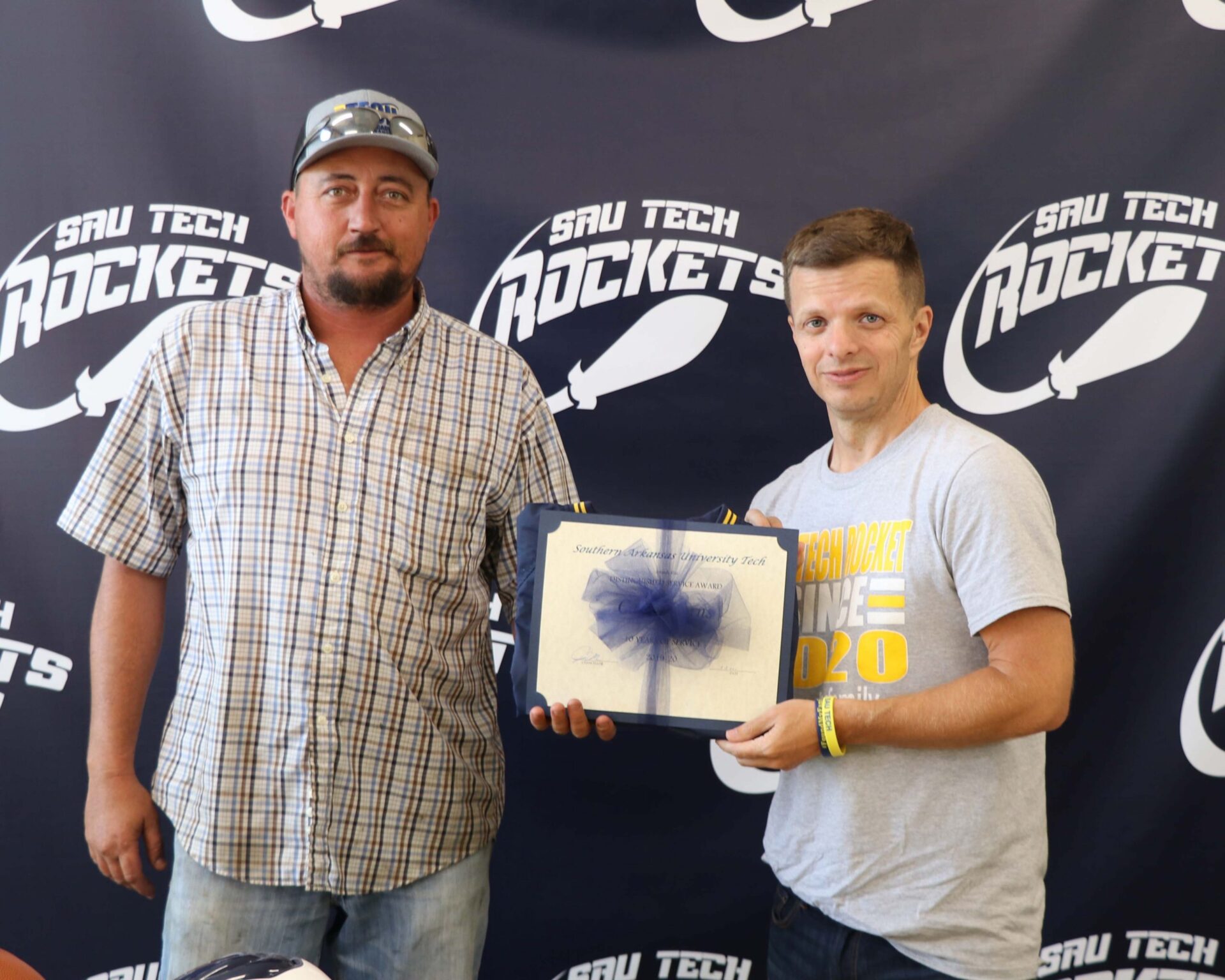 man with certificate and man in suit