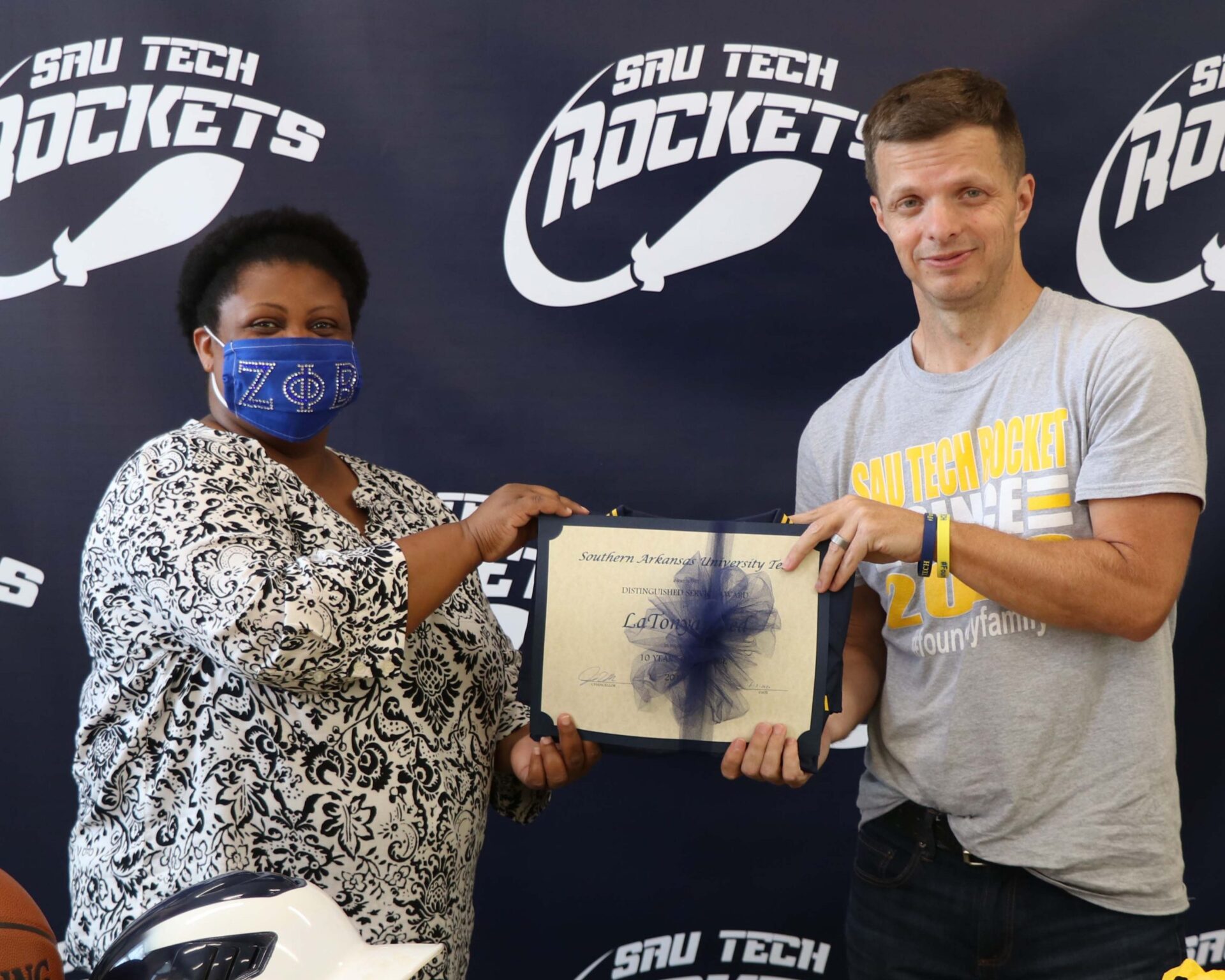 man with certificate and man in suit