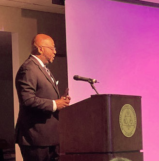 man in suit speaking