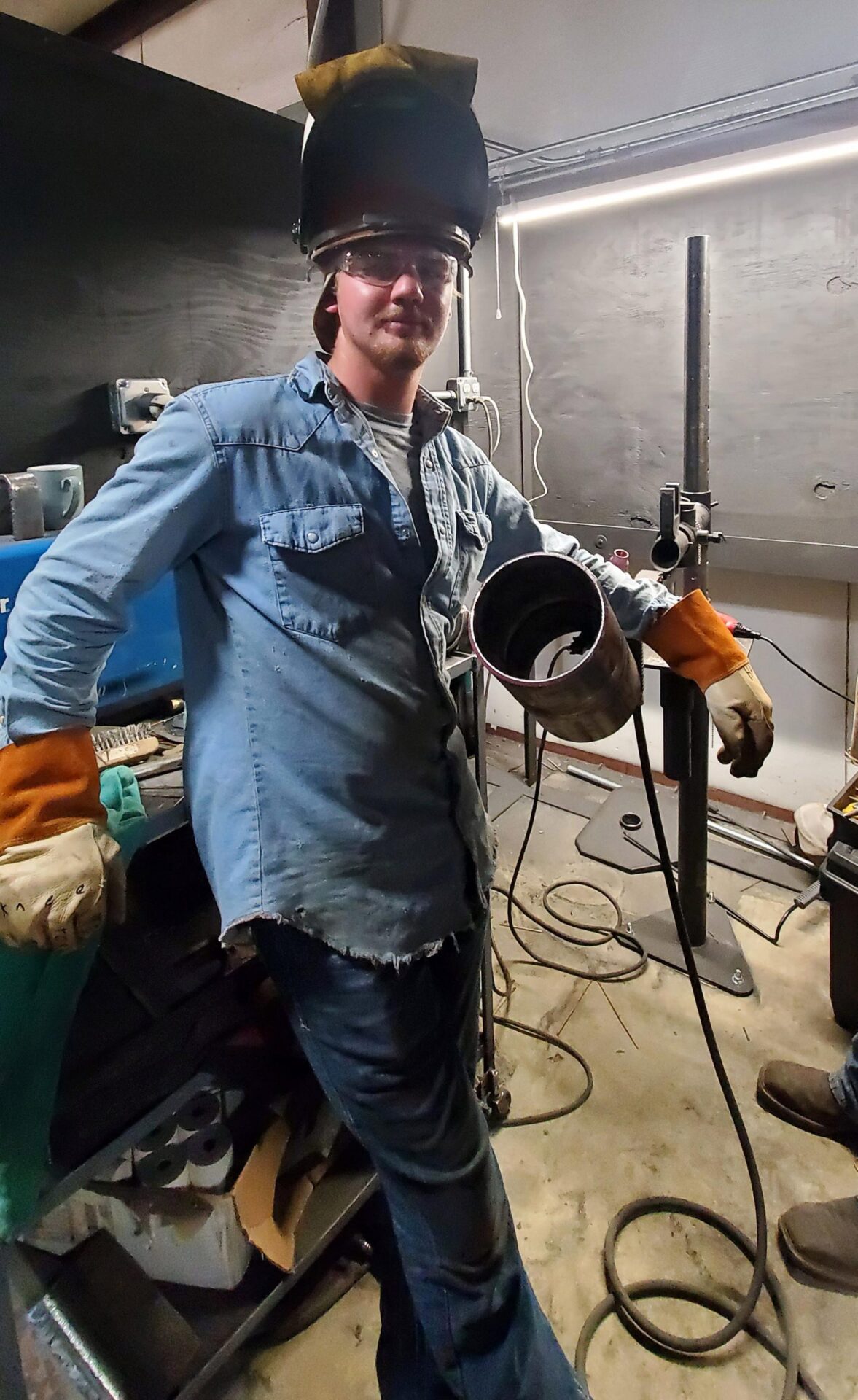 young man in a welding hood 