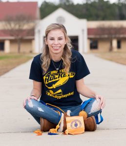 Blonde woman sitting and smiling