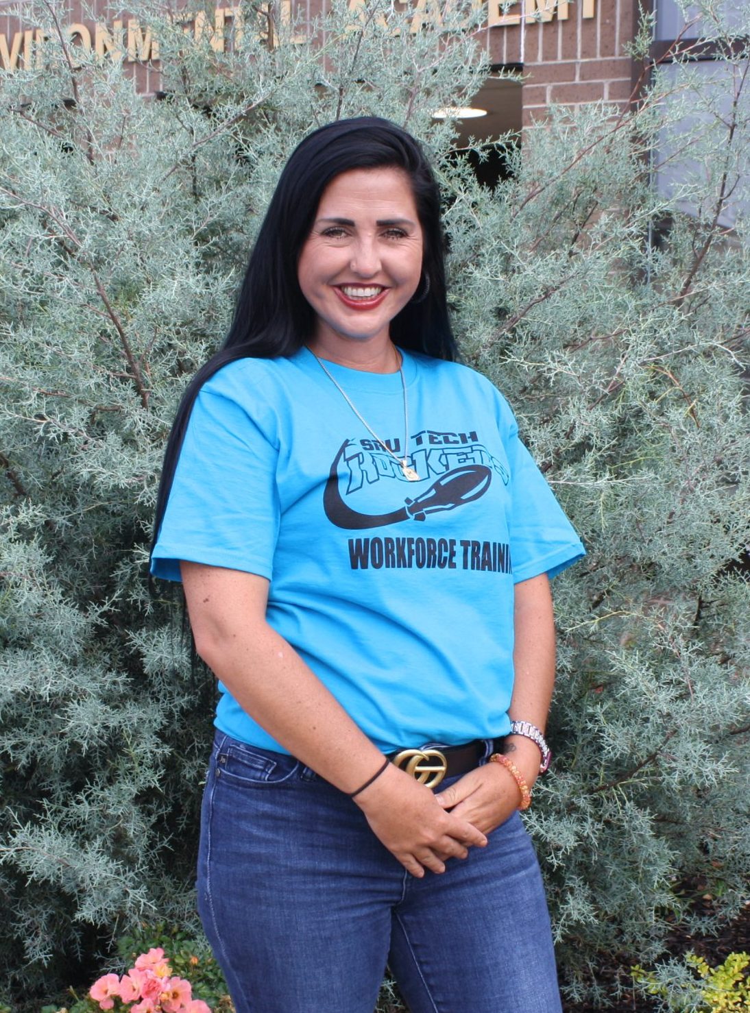 woman with long black hair in a blue shirt