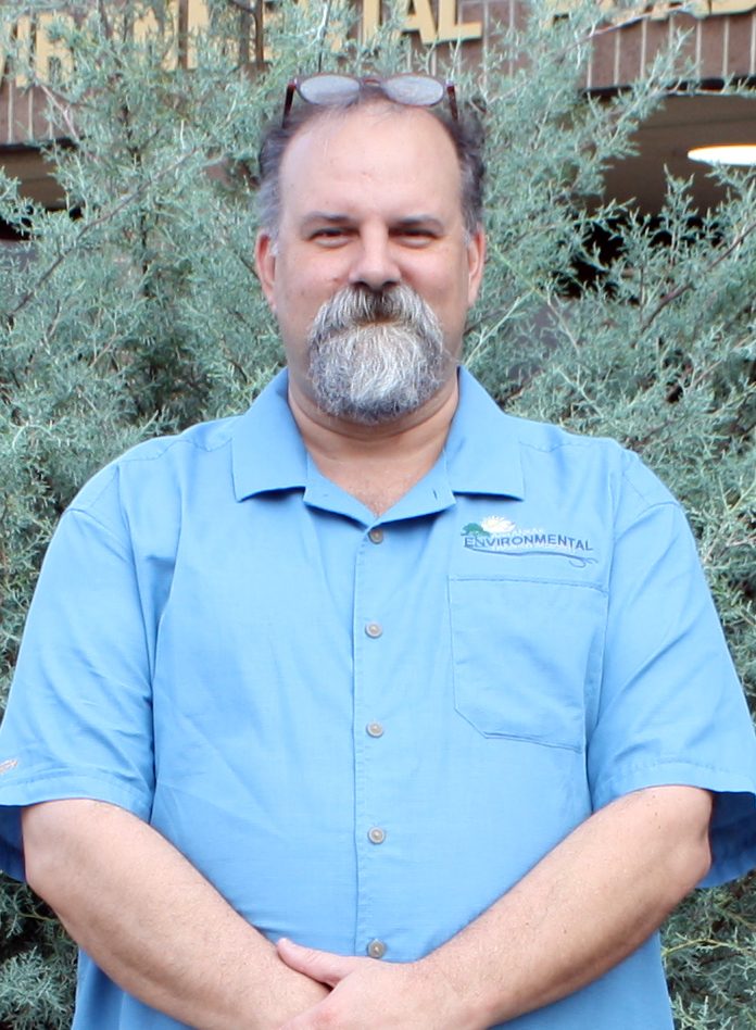 man in blue shirt with beard and glasses