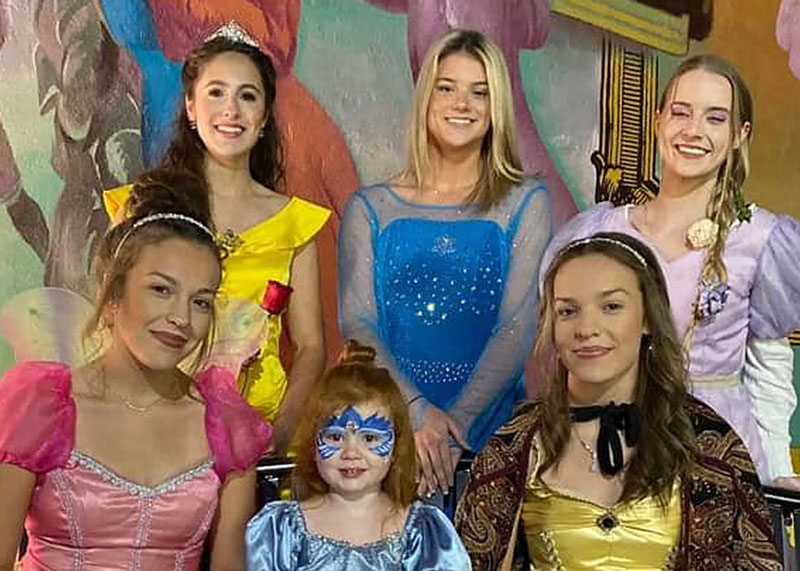 group of students dresses in disney costumes