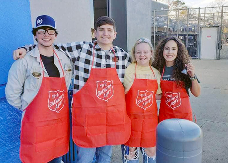 group of four students volunteering