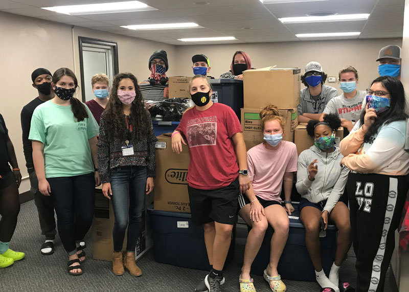 group of students collecting shoes to raise money
