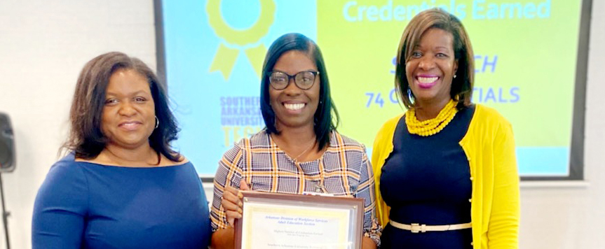 3 women in professional dress with certificate