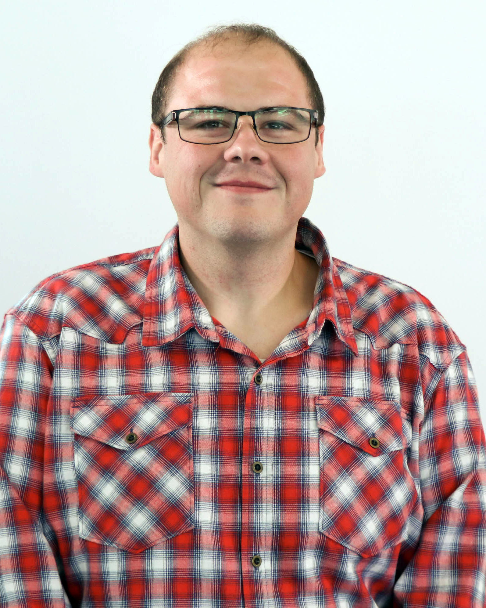 Man wearing a red plaid shirt and glasses
