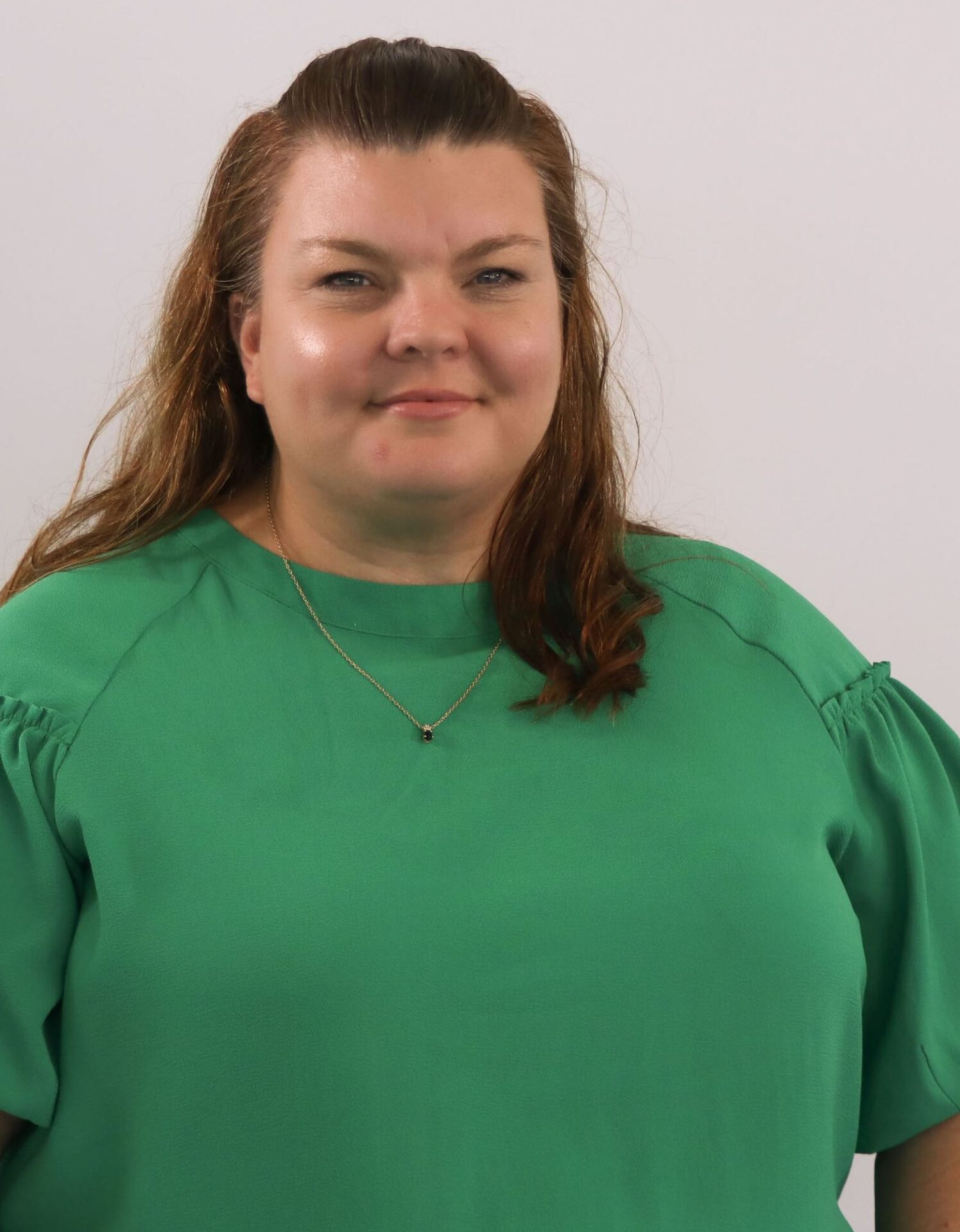 woman in green shirt smiling