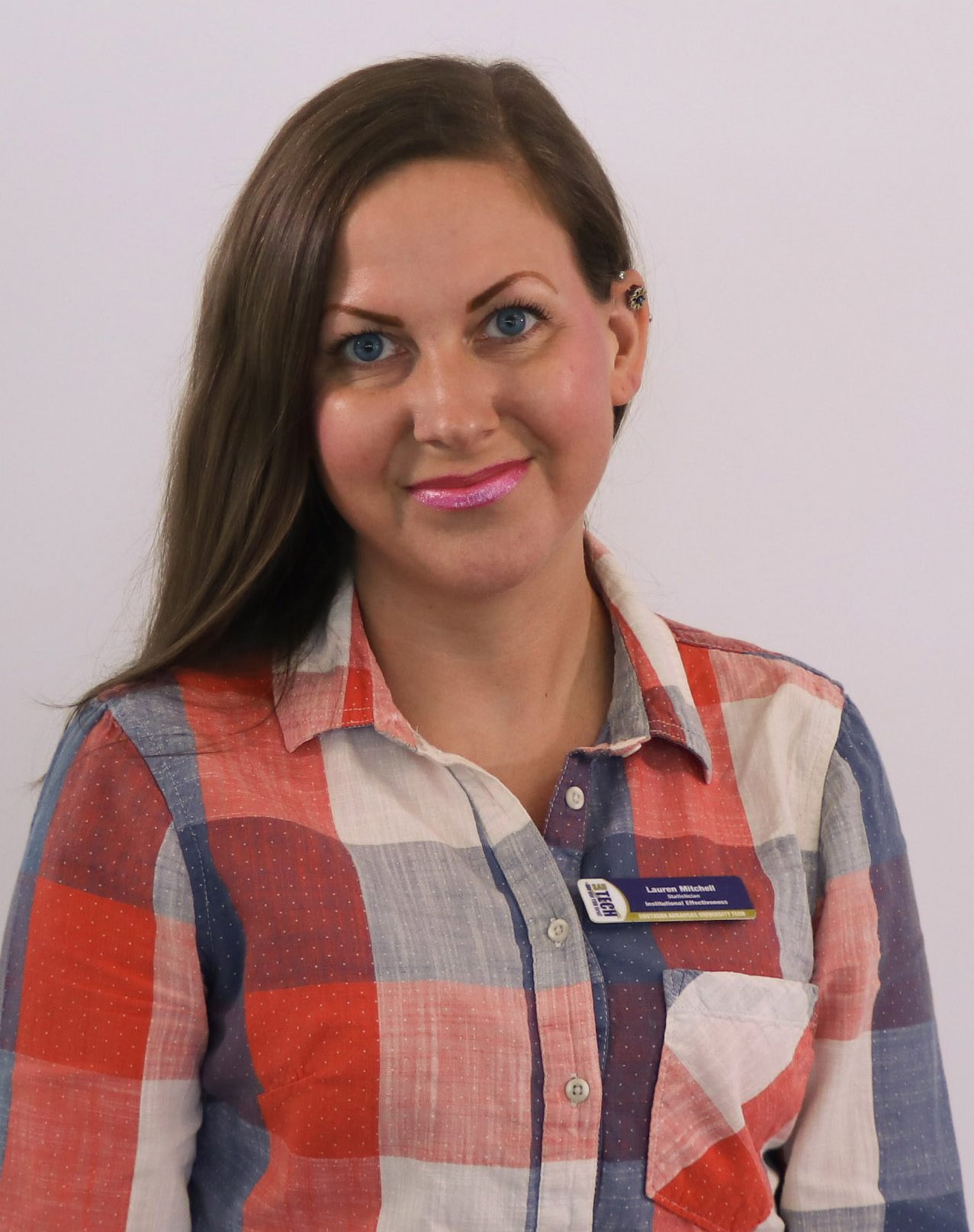 brunette woman in a plaid shirt