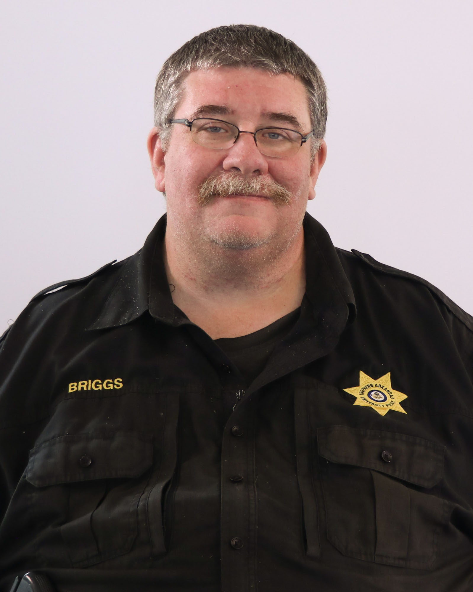 man with glasses in police uniform