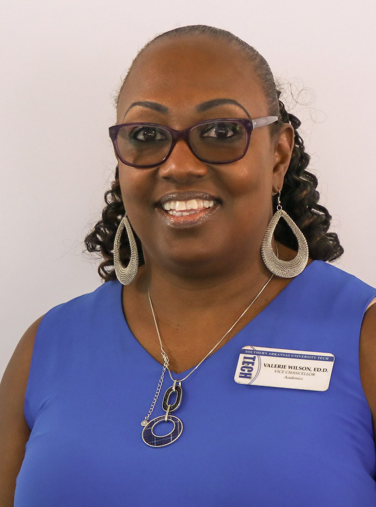 woman smiling wearing a blue top