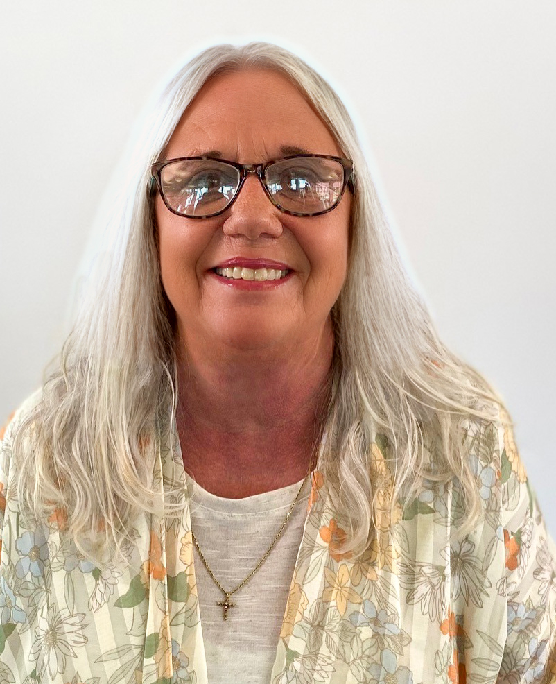 woman with long blond hair in floral shirt