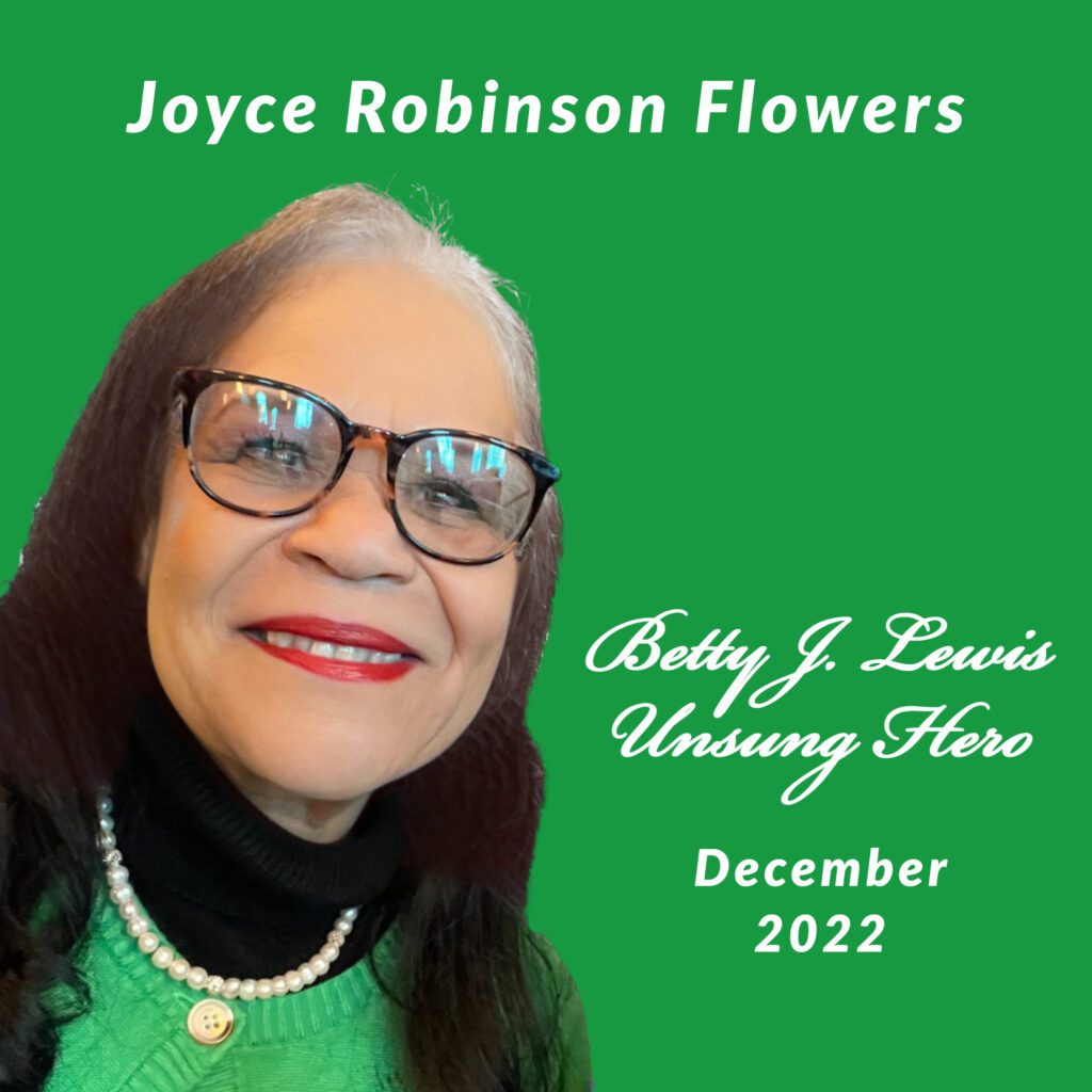 woman in a green sweater and glasses